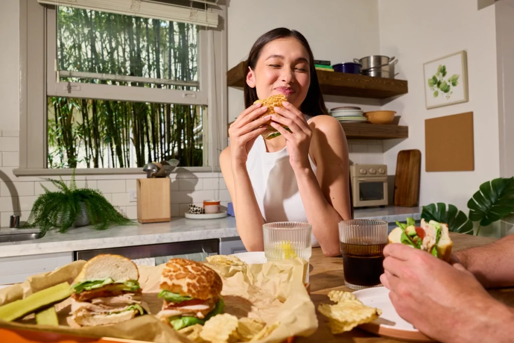 Attractive Woman Munching on Dutch Crunch Sandwich